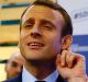 Presidential candidate Emmanuel Macron listens as he visits the Entrepreneurs Fair in Paris.