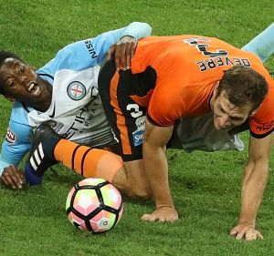 Melbourne City's Bruce Kamau cops the brunt of a challenge by Luke Devere.