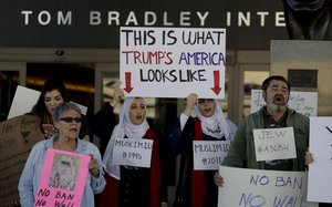 Demonstrators chant outside Tom Bradley International Terminal during a protest by airport service workers from United Service Workers West union Monday, Jan. 30, 2017, at Los Angeles International Airport.