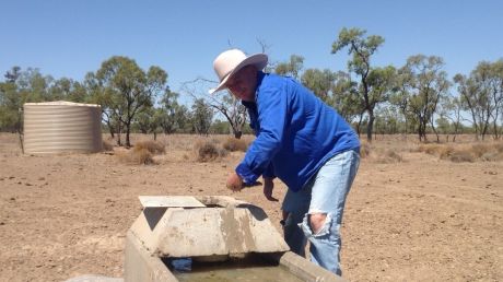 From flooding rains to searing heat: Chris Priestley examines a bore at the family's Salt Glen station near Carinda.