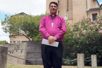 Bishop of Bunbury Allan Ewing standing outside a church.