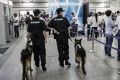 Police officers and sniffer dogs on patrol.