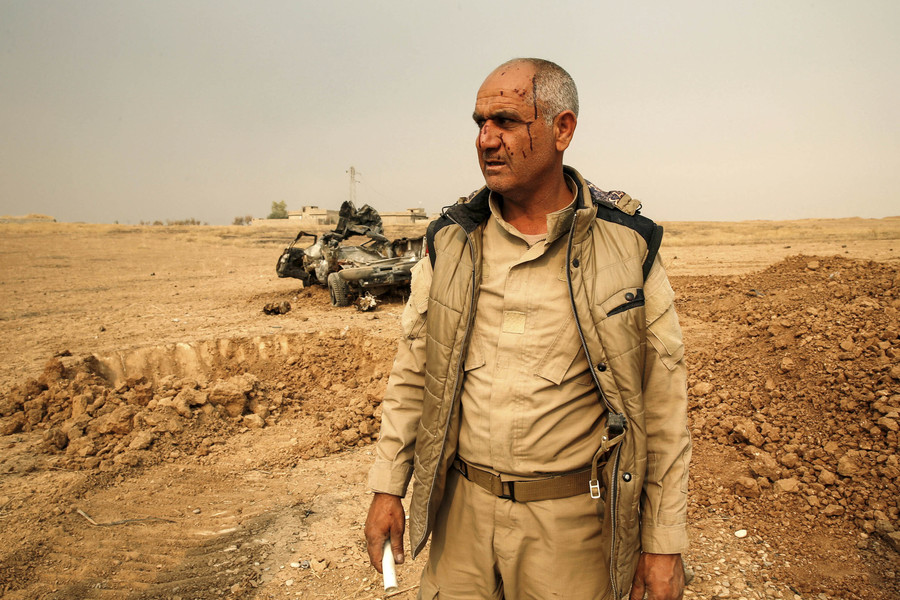 A Kurdish Peshmerga fighter following a road side bomb on their vehicle during a battle with Islamic State militants at Topzawa village near Mosul, Iraq October 24, 2016. (Ahmed Jadallah, Reuters)