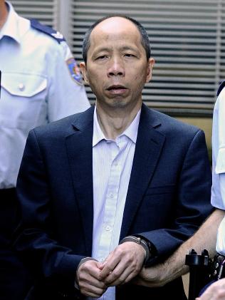 **FILE** A Friday, May 8, 2015 file phot of Lian Bin "Robert" Xie is escorted to a prison transport vehicle at the Supreme Court of NSW in Sydney. Robert Xie has been found guilty of murdering five of his wife's relatives, more than seven years after the family was bludgeoned in their Sydney home. (AAP Image/Joel Carrett) NO ARCHIVING