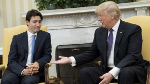 President Donald Trump, right, extends his hand to Justin Trudeau, Canada's prime minister, during a meeting in the Oval ...