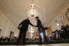 US President Donald Trump shakes hands with Canadian Prime Minister Justin Trudeau (R) in front of press