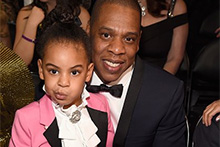 Jay Z holds his daughter, Blue Ivy, who is dressed like Prince (Twitter: FreddyAmazin)