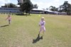 Preschooler in a running race on a school oval.