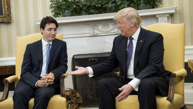 President Donald Trump, right, extends his hand to Justin Trudeau, Canada's prime minister, during a meeting in the Oval ...