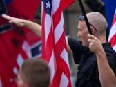 A member of a white supremacy group gives the fascist salute in West Allis, Wisconsin, September 2011. 