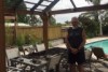 Peter Smider stands next to his destroyed gazebo.