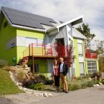 Dave Spencer and Debbie Wiltshire in front of their net-zero home. They wanted to develop a green community in Calgary and started the process more than 12 years ago. The concept turns traditional suburban neighbourhoods on its ear. Photo David Dodge, Green Energy Futures