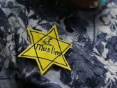 A woman wears a pin during a rally against Muslim immigration ban at San Francisco International Airport, January 28, 2017.