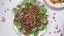 Spinach salad with spicy beef and candied pistachios.