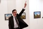 Mevlut Mert Altintas shouts after shooting Andrei Karlov, right, the Russian ambassador to Turkey, at an art gallery in ...