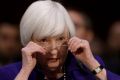 Janet Yellen, chair of the US Federal Reserve, adjusts her glasses during a Senate Banking, Housing, and Urban Affairs ...