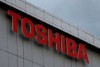 The Toshiba Corporation logo in front of dark skies.