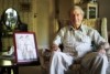 Colin Hamley sitting in an armchair at home in Melbourne