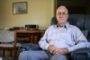 James Kerr from Melbourne at home sitting on his armchair. 