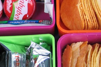 A lunch box filled with snack foods.