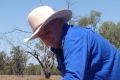 From flooding rains to searing heat: Chris Priestley examines a bore at the family's Salt Glen station near Carinda.