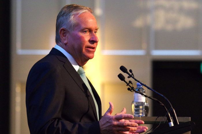 WA Premier Colin Barnett n front of microphones at a lectern