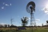 A windmill on Undoolya station with a new solar panel beside it