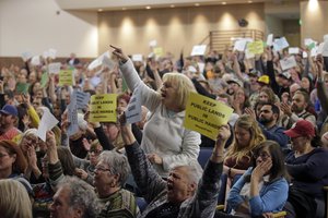 Tami Sablan shouts as Rep. Jason Chaffetz speaks during a town hall meeting at Brighton High School, Thursday, Feb. 9, 2017, in Cottonwood Heights, Utah.