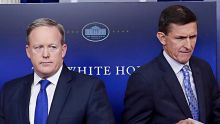 National Security Adviser Michael Flynn walks past White House press secretary Sean Spicer to the podium to speak during ...