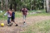 Tully, 11, George, 9 and Eden, 11 playing in the school yard with the bushland as their backdrop.