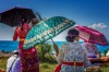A trio of umbrellas and vibrant colour at the melasti Hindu festival, Bali, Indonesia.