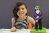 Young artist Violet with her Joker sculpture