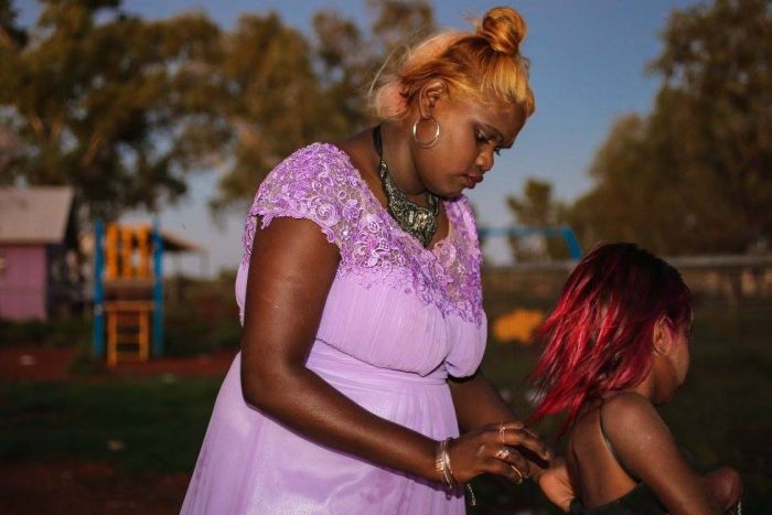 A photo of two females getting ready for the Kiwirrkurra Fashion Show