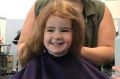 Canberra hairdresser Nicole McDonald with Ava Wright, three. Nicole is giving free hair cuts to all red heads on March 3.