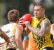 Dustin Martin runs with the ball.