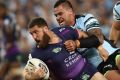 The Storm's Kenny Bromwich is tackled during the 2016 grand final against Cronulla.