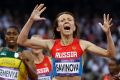 Russia's Mariya Savinova celebrates as she crosses the finish line ahead of South Africa's Caster Semenya during at the ...