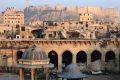 Aleppo citadel, background, and the heavily damaged inside the Grand Umayyad mosque in the old city of Aleppo, Syria.