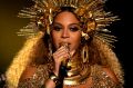 In a display of regal brilliance, a heavily pregnant Beyonce performs at the Grammys.