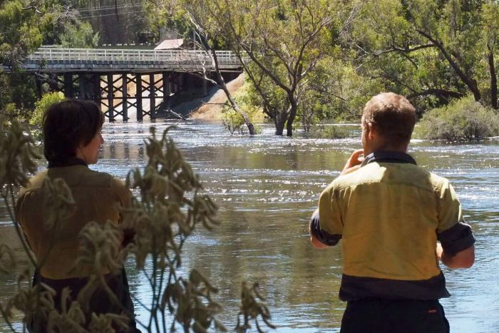 Locals watch the high water level of the Blackwood River in Bridgetown. 