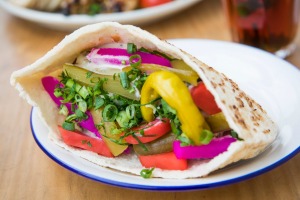 Pita filled with colourful pickles and falafel.