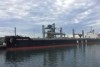 Large ship African Finfoot with cranes and towers sits low in the water at Port Kembla