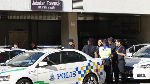 Police officers wait at the forensic department entrance at a hospital in Putrajaya, Malaysia, where Kim Jong-nam's body ...