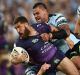 The Storm's Kenny Bromwich is tackled during the 2016 grand final against Cronulla.