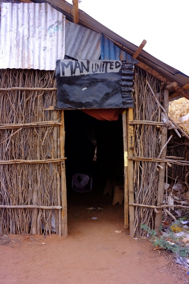 This hut is also the cinema where refugees, many of whom support Manchester United, watch the English Premier League.