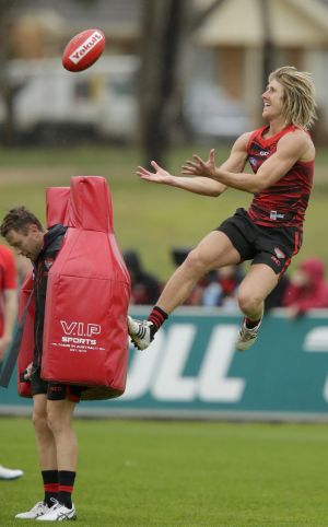 Up, up: Heppell has a spring in his step at Essendon training.