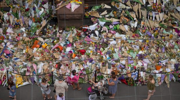 People lay flowers at the memorial to the victims in the wake of last month's Bourke Street attack.