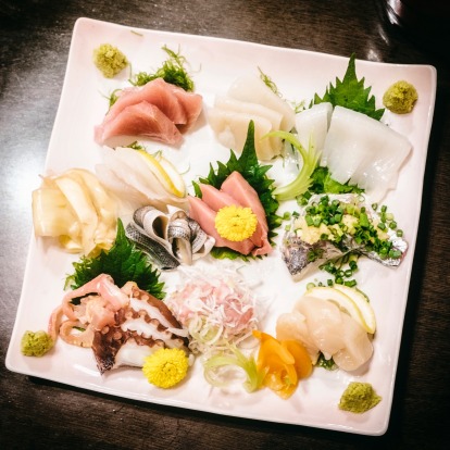 A top-down view of a traditional Japanese sashimi plate.
