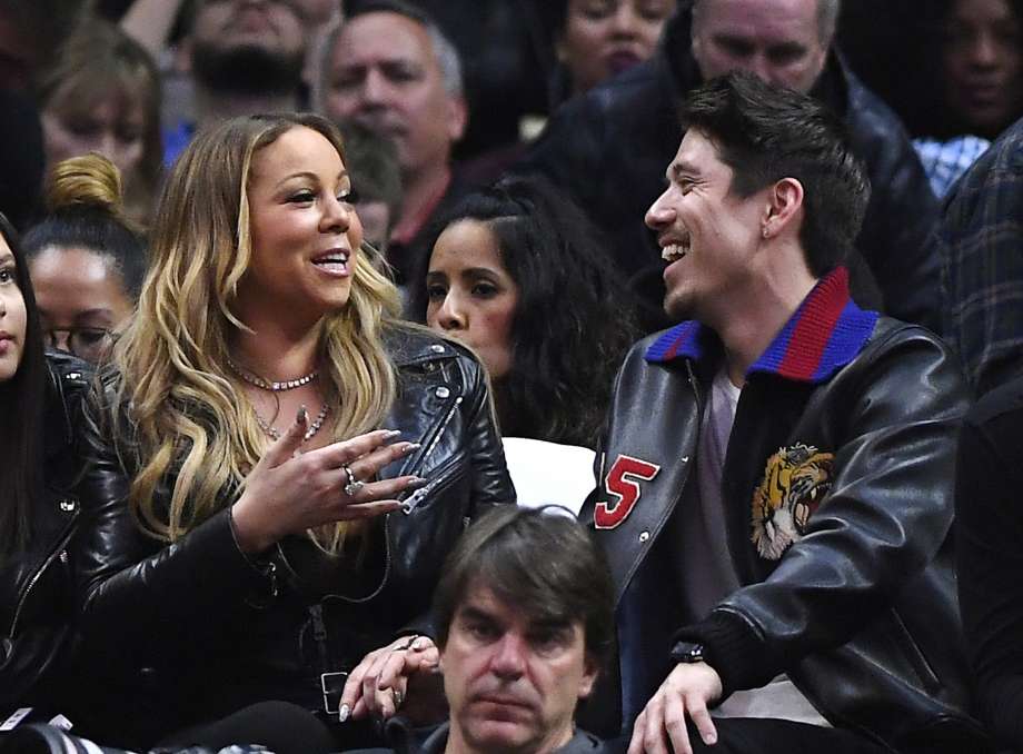 Singer Mariah Carey, left, talks with Bryan Tanaka during the second half of an NBA basketball game between the Los Angeles Clippers and the Atlanta Hawks, Wednesday, Feb. 15, 2017, in Los Angeles. The Clippers won 99-84. Photo: Mark J. Terrill, AP / Copyright 2017 The Associated Press. All rights reserved.