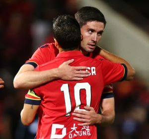 Coolly done: Dylan McGowan congratulates Marcelo Carrusca, who scored the winning goal.